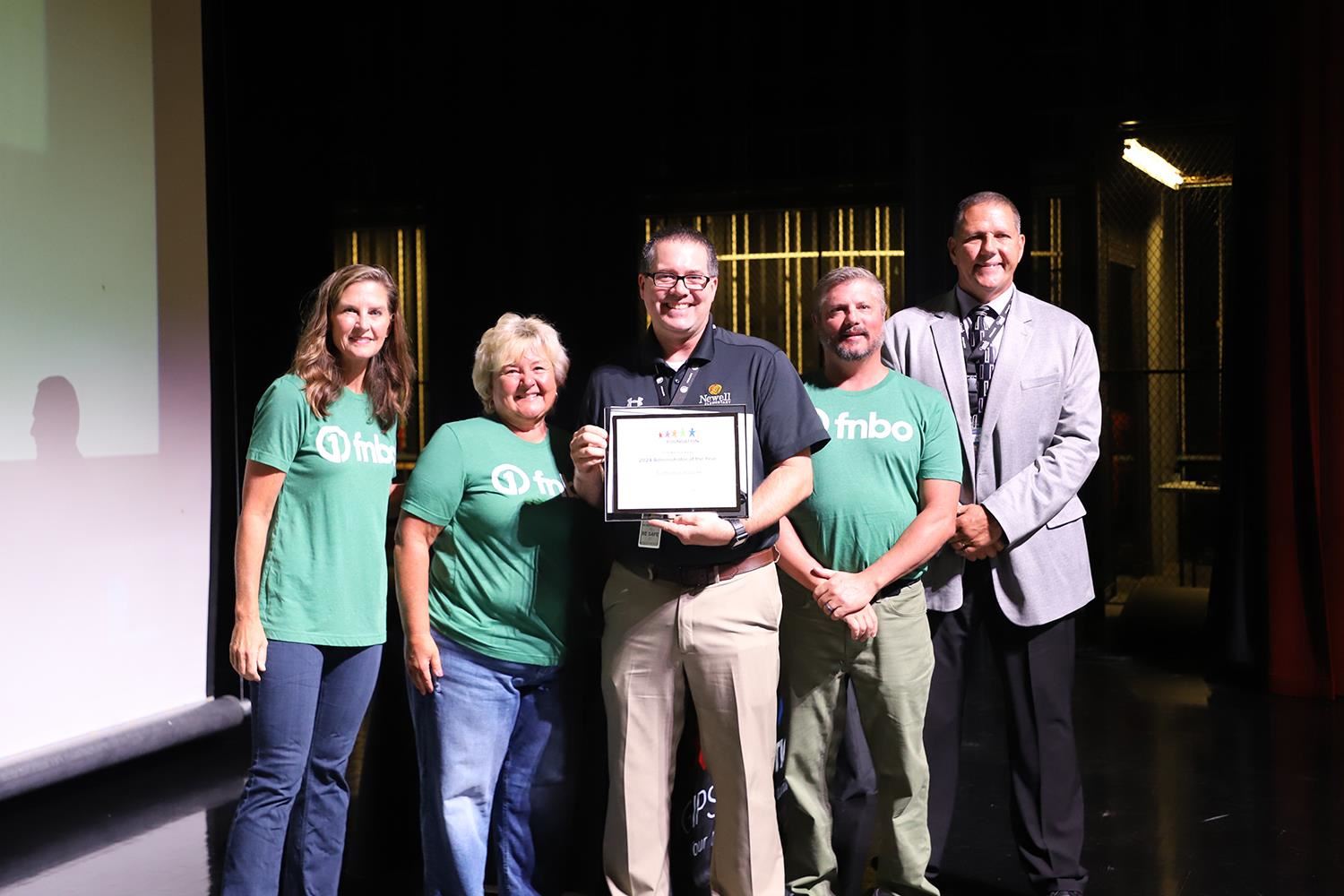 Nate Balcom accepting his Teacher of the Year Award on stage at GIPS Welcome Back.